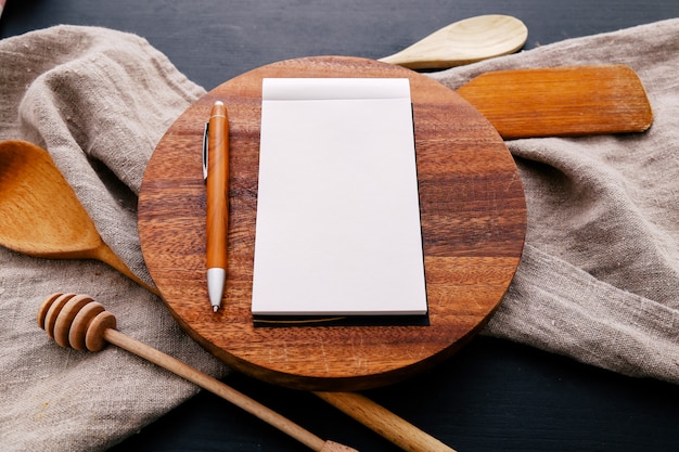 Cooking equipment on kitchen counter and notebook