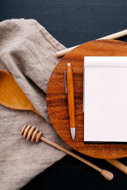 Cooking equipment on kitchen counter and notebook