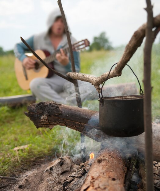 cooking fresh food in cauldron at camp on open fire