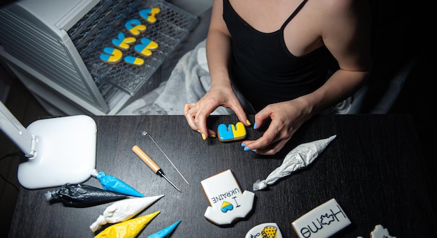 Cooking of handmade gingerbread with symbols of ukraine icing