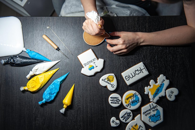 Free photo cooking of handmade gingerbread with symbols of ukraine icing