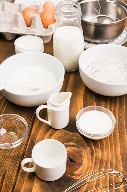 Cooking ingredients and utensils over brown textured desk