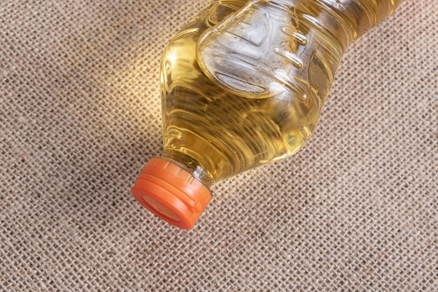 Cooking oil on the brown jute background