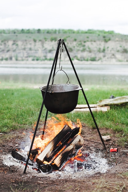 Cooking pot hanging over burning firewood