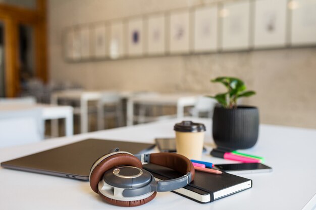 Cool different office stationery arranged on white table in co-working office