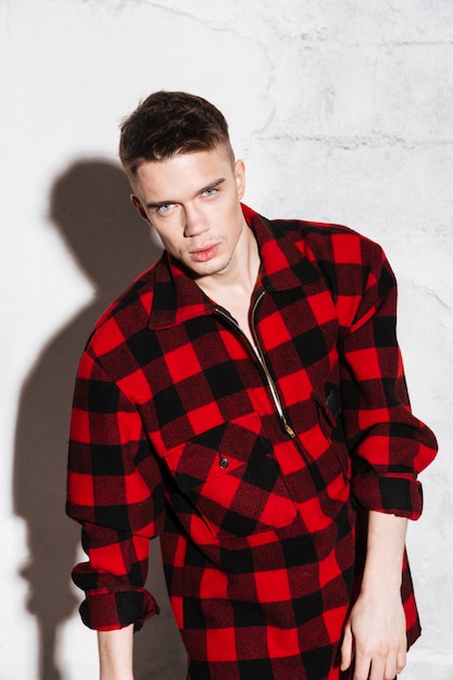 Free photo cool fashion man posing with plaid shirt