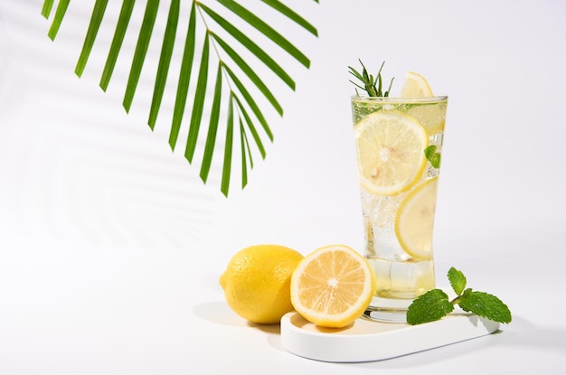 Free photo cool freshly made lemonade ice cubes and lemon fruits on white table background