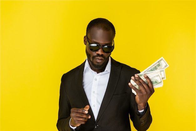 Cool man holding dollars