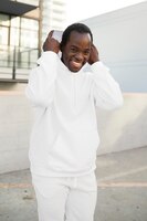 Cool man in white hoodie and sweatpants men’s fashion apparel shoot