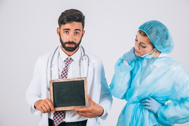 Cool medical team posing with blackboard