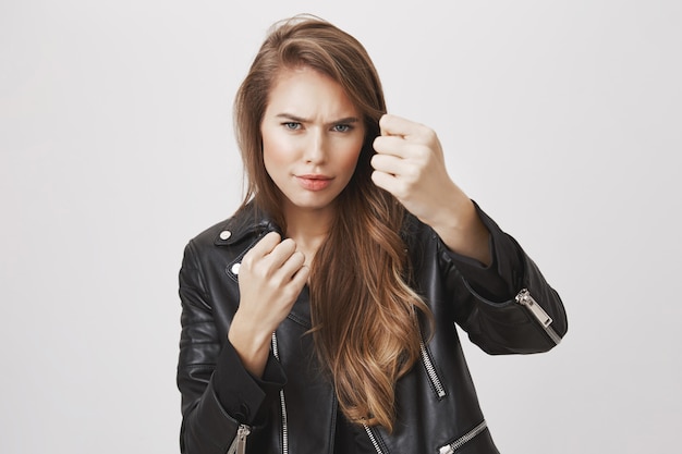 Cool and sassy woman clench fists, standing boxer pose