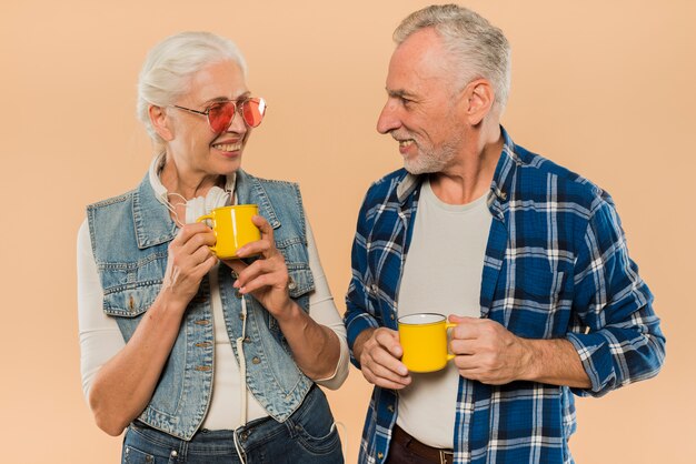 Cool senior couple with mugs
