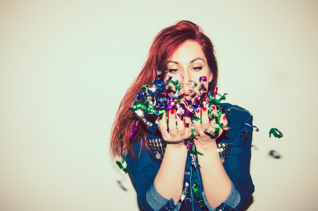 Free photo cool woman playing with confetti