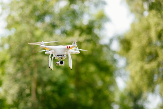 Free photo copter with digital camera flying high in the air, taking photos