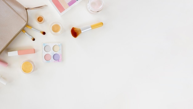 Copy-space bag with cosmetics on desk