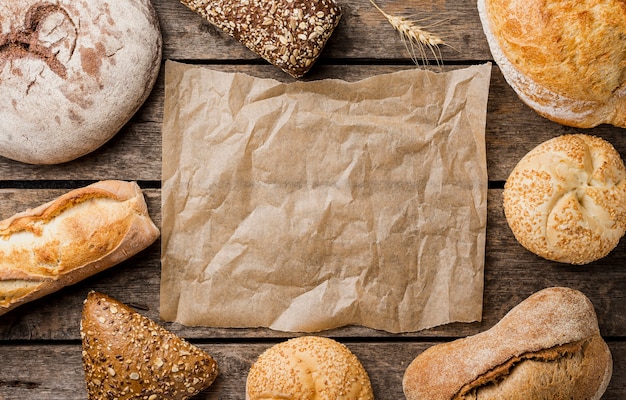 Copy space baking paper surrounded by bread