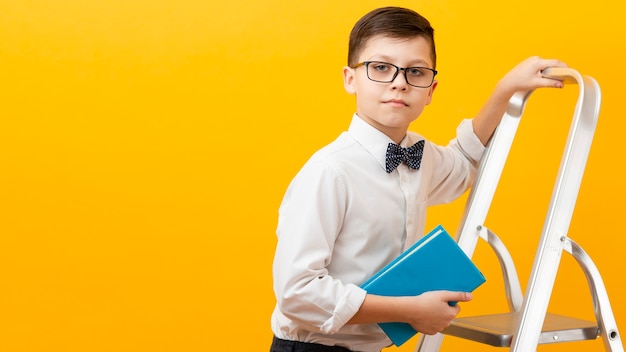 Free photo copy-space boy holding book