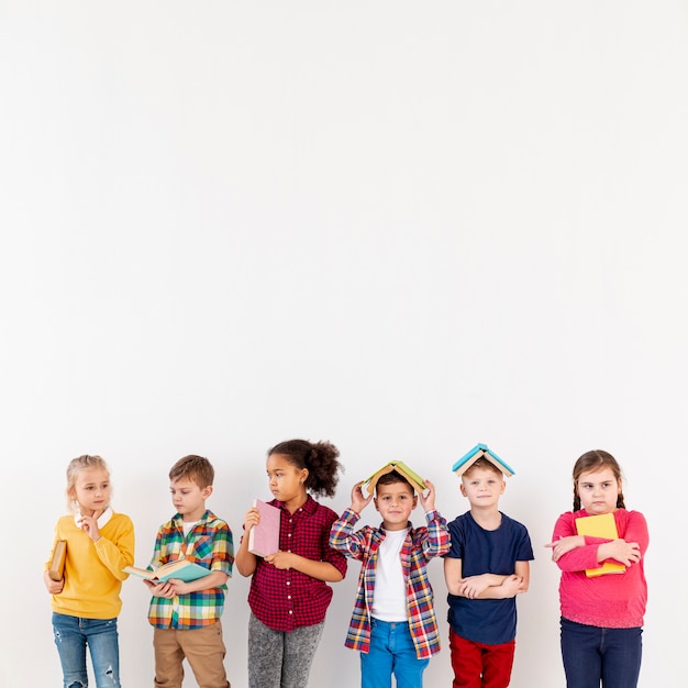 Copy-space childrens with book on their heads