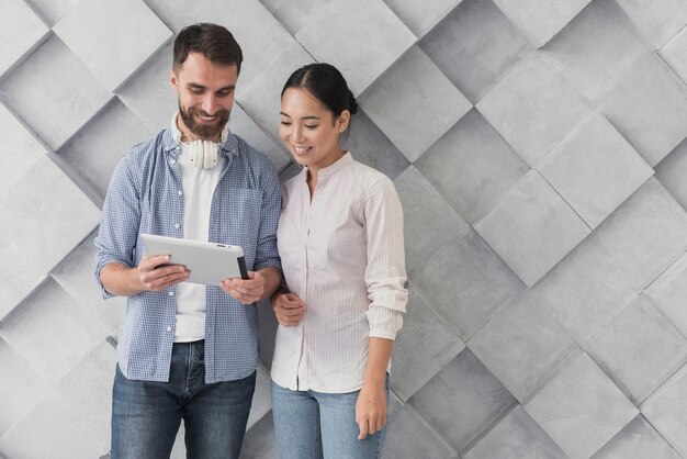 Copy-space coworkers looking at tablet