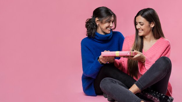 Copy-space girl giving gift to mother