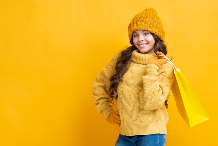 Free Photo copy-space girl with winter shopping clothing bag