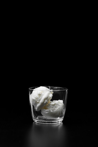 Free photo copy-space glass with vanilla flavored ice cream