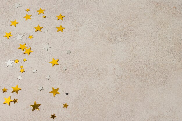 copy-space golden festive stars on table