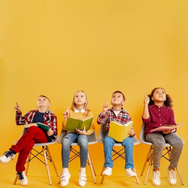 Copy-space group of childrens with books pointing