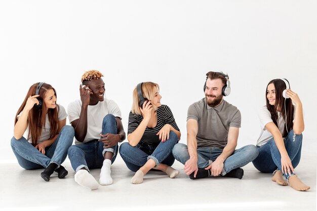 Copy-space group of friends sitting on floor