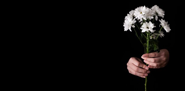 Copy-space hand with bouquet of flowers