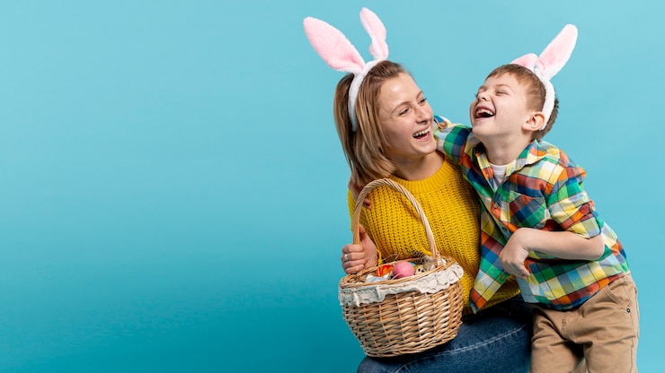 Free Photo copy-space happy mother and son with basket of painted eggs