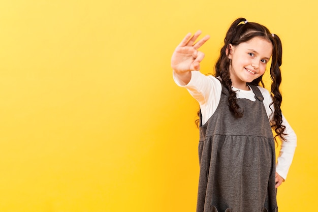 Copy-space little girl showing ok sign