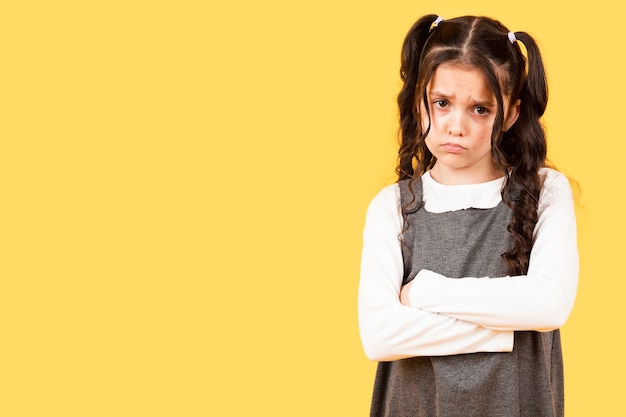 Copy-space little girl upset on yellow background