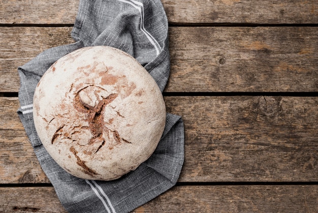 Copy space round bread on cloth and wooden background