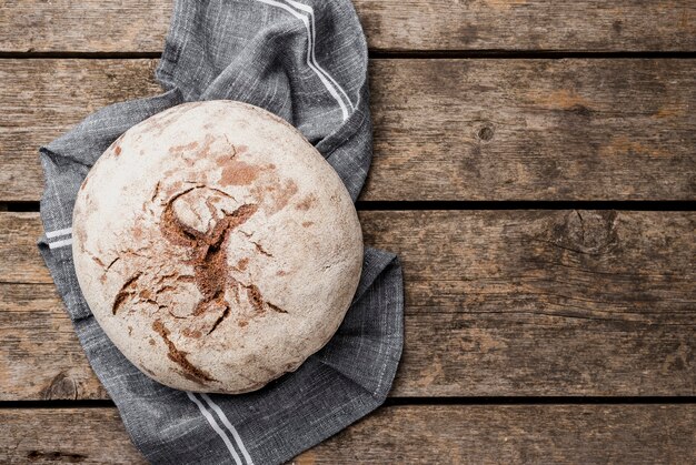 Copy space round bread on cloth and wooden background