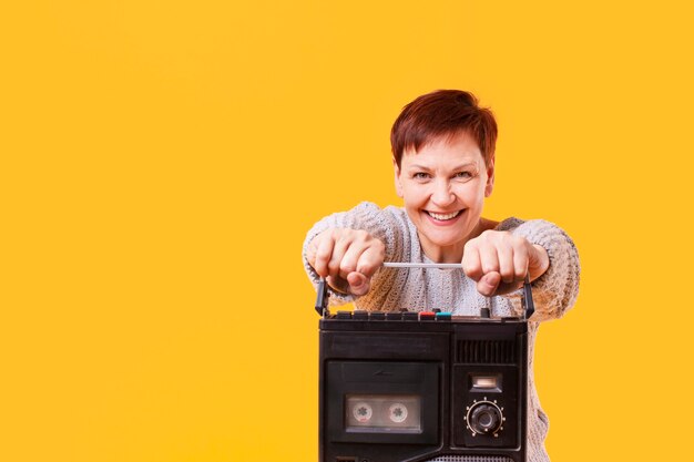copy-space smiley woman with cassette
