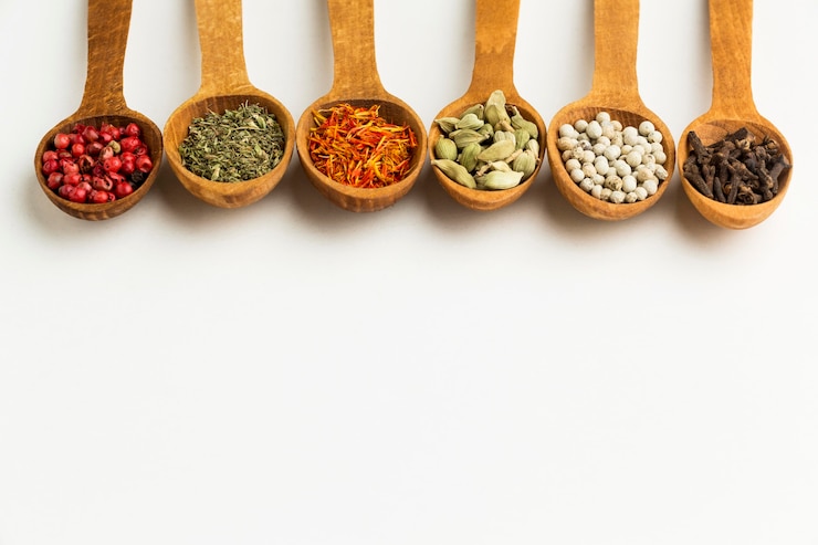 Free Photo copy-space variety of spices in wooden spoons