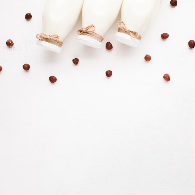 Copy space white background with milk and hazelnuts