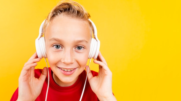 Copy-space young boy listening music