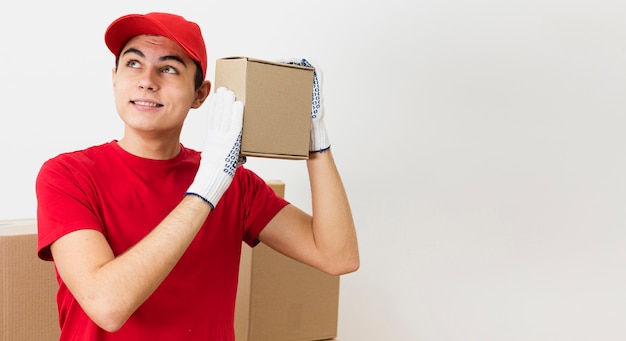 Copy-space young delivery man carrying packages