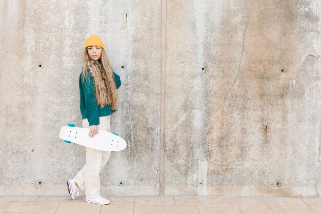 Copy-space young woman with skateboard