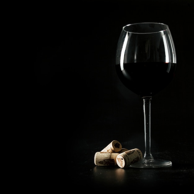 Corks near glass of wine