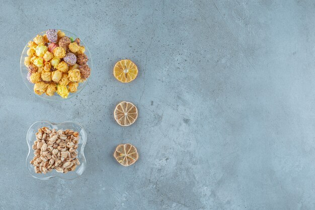 Corn balls in a glass and cornflakes in a milk coffee glass , on the blue background.