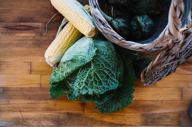 Corn and cabbage near basket