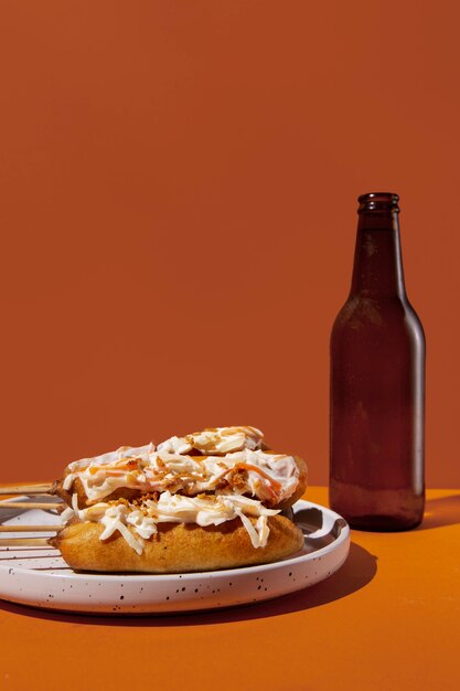 Corn dogs on plate and bottle arrangement