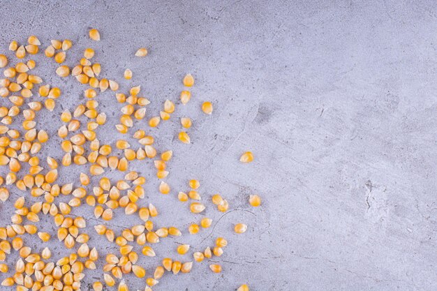 Corn kernels scattered on marble background. High quality photo