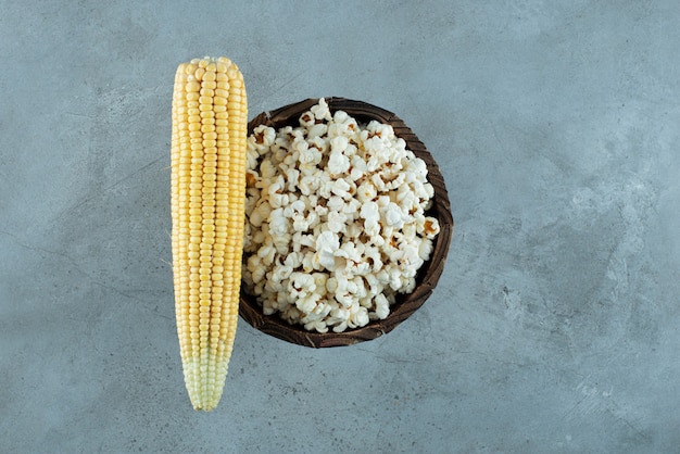 Corn plant seeds and popcorns on blue background. high quality photo