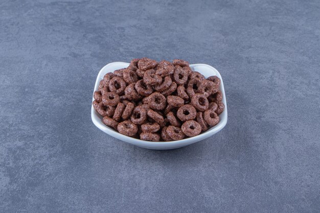 Corn rings in a bowl , on the marble background.