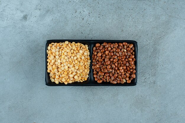 Corn seeds and brown beans on a wooden platter. High quality photo