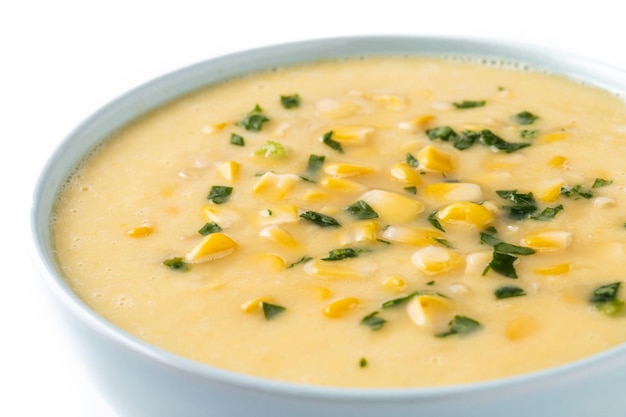 Corn soup in white bowl isolated on white background